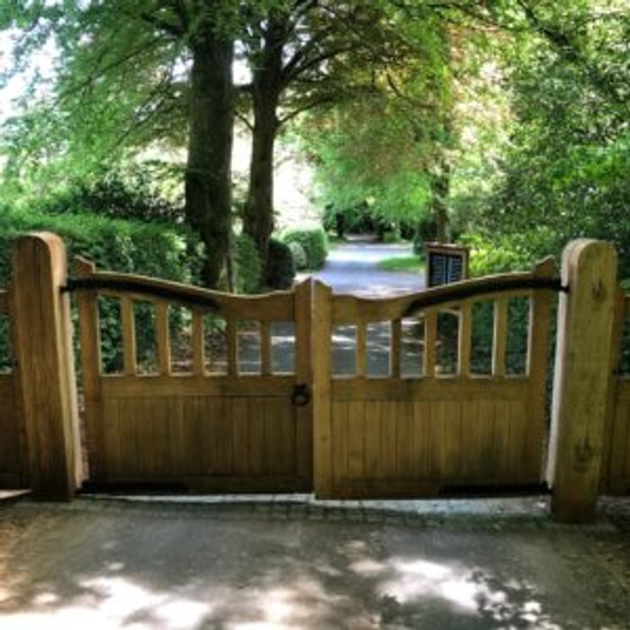 Weathered timber gates before repair and repainting
