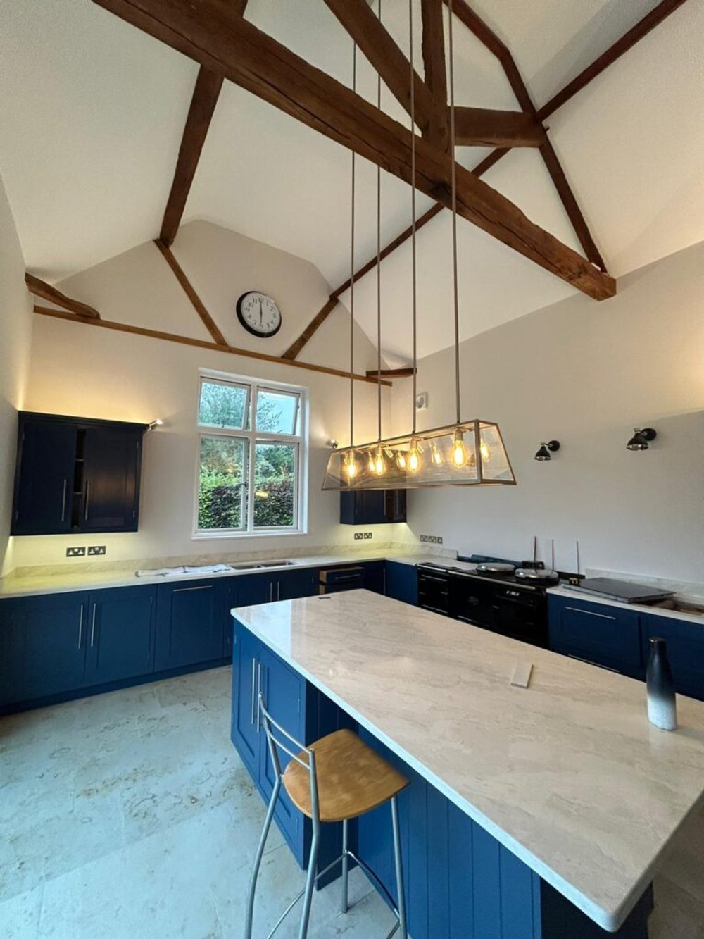Hand-painted navy kitchen in a beamed room